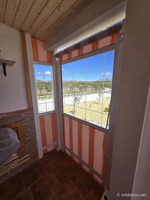 Toldo vertical con ventana de cristal, instalado por Toldobox